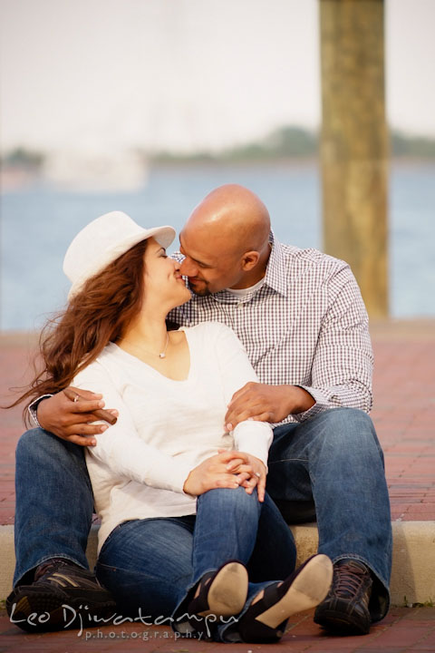 Engaged guy cuddling his fiancée by the pier. Annapolis Maryland USNA Pre-Wedding Engagement Photo Session by wedding photographer Leo Dj Photography