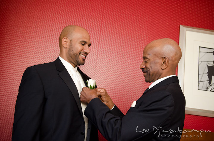 Groom getting help from father putting boutonniere. The Grand Marquis, Old Bridge, New Jersey wedding photos by wedding photographers of Leo Dj Photography. 
