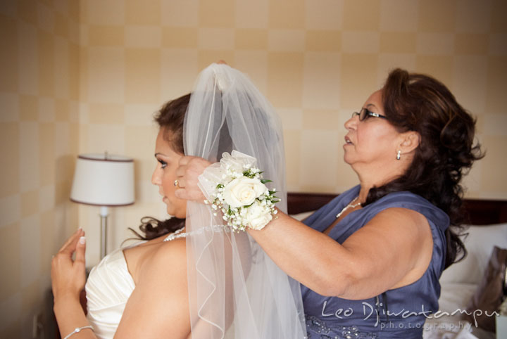 Mother putting on veil on bride. The Grand Marquis, Old Bridge, New Jersey wedding photos by wedding photographers of Leo Dj Photography. 