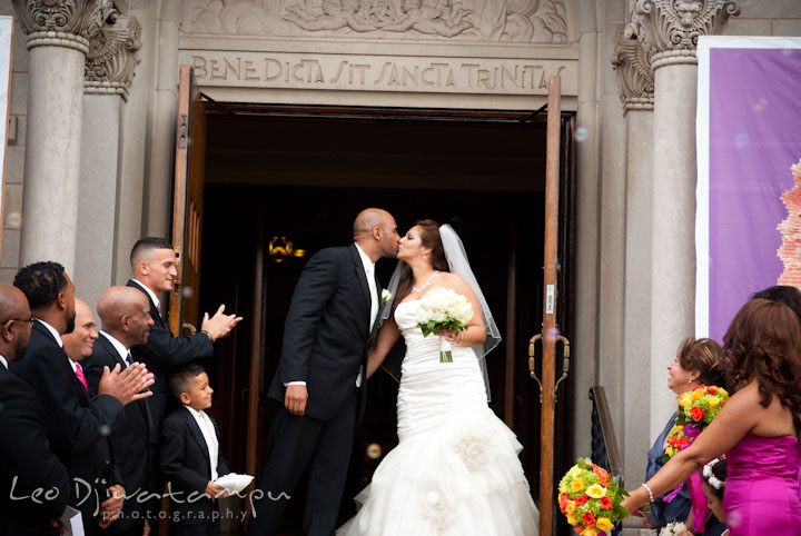 Bride groom kissing in church front door. The Grand Marquis, Old Bridge, New Jersey wedding photos by wedding photographers of Leo Dj Photography. 