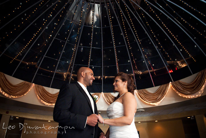 Bride and groom holding hand under the dome. The Grand Marquis, Old Bridge, New Jersey wedding photos by wedding photographers of Leo Dj Photography.