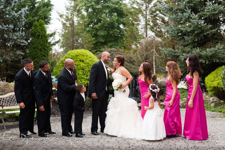 Bride and groom laughing with whole bridal wedding party. The Grand Marquis, Old Bridge, New Jersey wedding photos by wedding photographers of Leo Dj Photography.