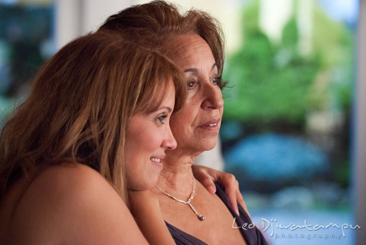 Bridesmaid and mother of bride looking at bride and groom dancing. The Grand Marquis, Old Bridge, New Jersey wedding photos by wedding photographers of Leo Dj Photography.