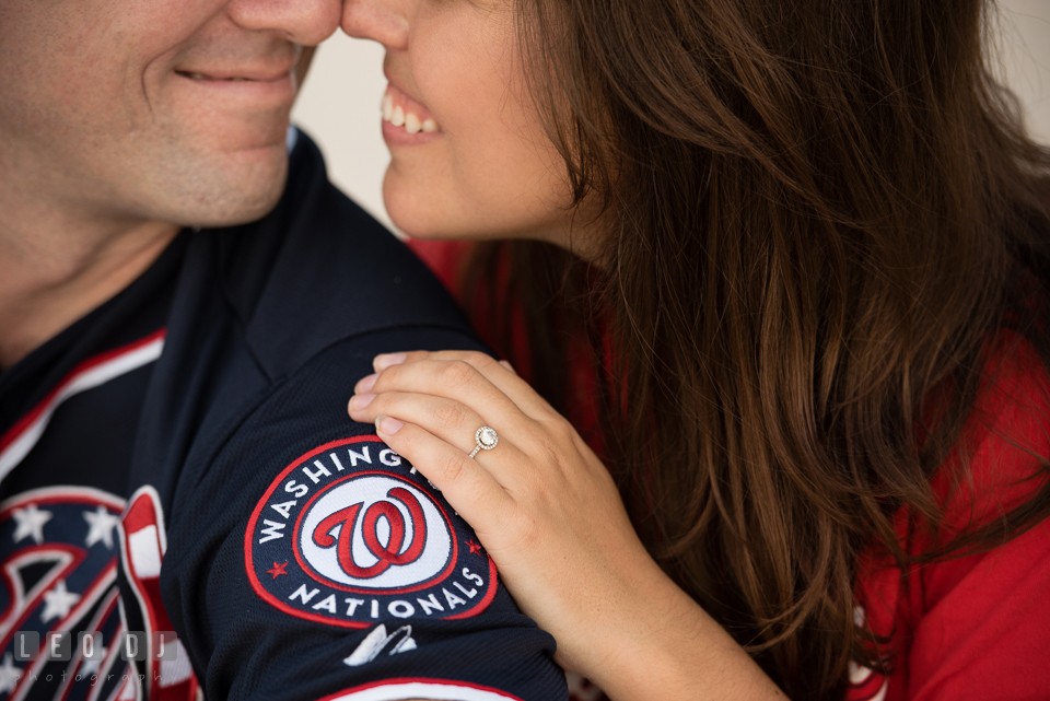 Engaged girl and her fiance with MLB Washington Nationals jersey and cap showing her beautiful diamond engagement ring. Leesburg Virginia pre-wedding engagement photo session at River Creek Club, by wedding photographers of Leo Dj Photography. http://leodjphoto.com