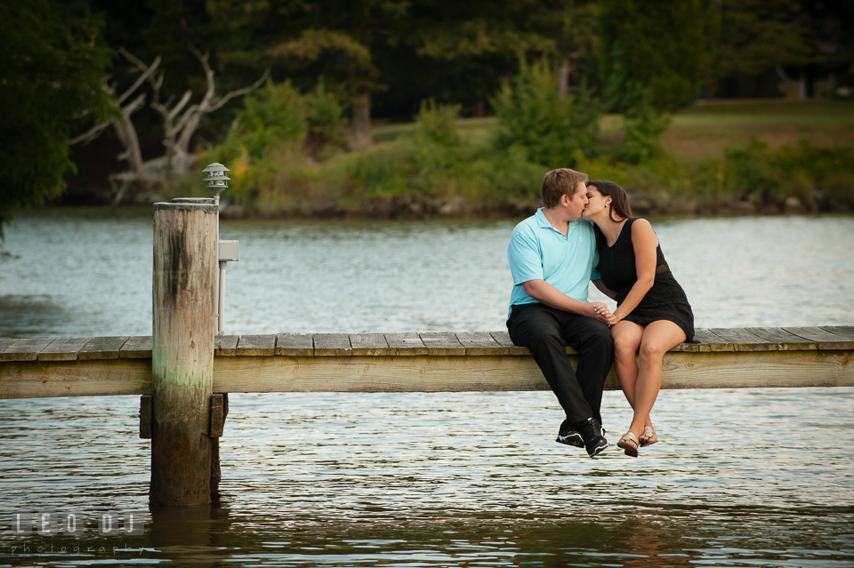 Engaged man kissing his fiancee at a dock. Eastern Shore Maryland pre-wedding engagement photo session at Easton MD, by wedding photographers of Leo Dj Photography. http://leodjphoto.com