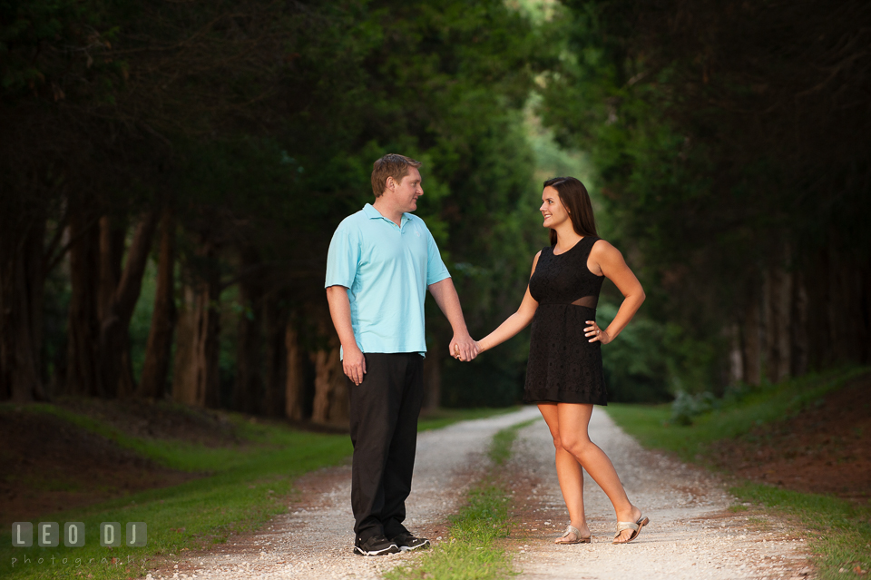 Engaged couple in the woods holding hands looking at each other. Eastern Shore Maryland pre-wedding engagement photo session at Easton MD, by wedding photographers of Leo Dj Photography. http://leodjphoto.com