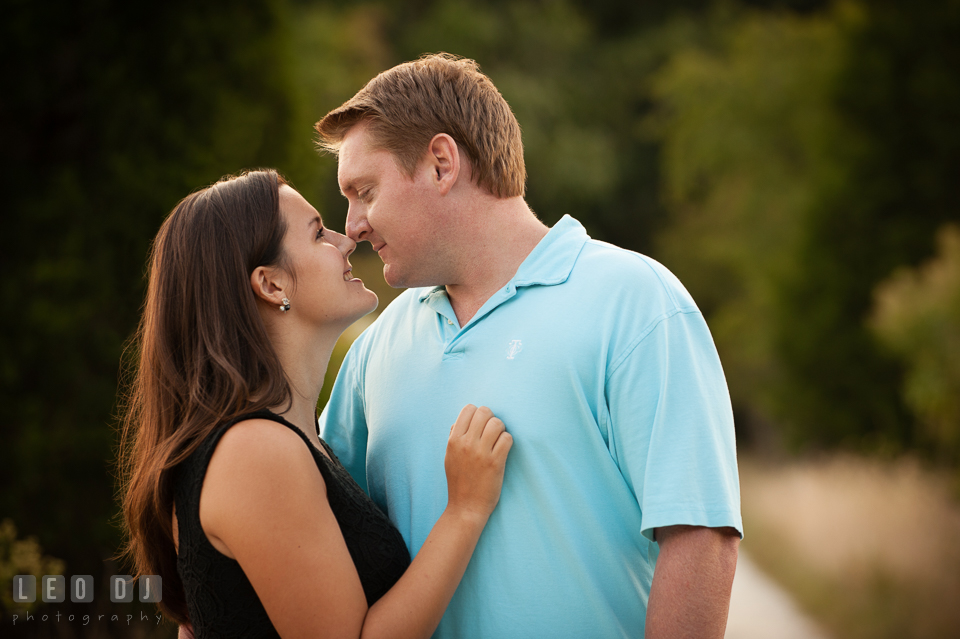 Engaged woman snuggled with her fiance by the woods. Eastern Shore Maryland pre-wedding engagement photo session at Easton MD, by wedding photographers of Leo Dj Photography. http://leodjphoto.com