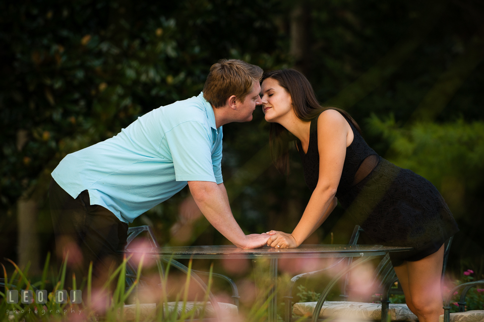 Engaged girl almost kissed her fiance in a flower garden. Eastern Shore Maryland pre-wedding engagement photo session at Easton MD, by wedding photographers of Leo Dj Photography. http://leodjphoto.com