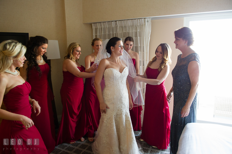 Bridesmaids, Maid of Honor, and Mother helping Bride put on wedding dress. Hyatt Regency Chesapeake Bay wedding at Cambridge Maryland, by wedding photographers of Leo Dj Photography. http://leodjphoto.com