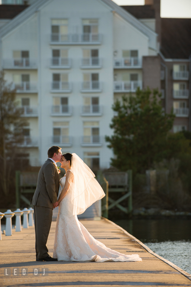 Groom kisses Bride's forehead at the boat dock. Hyatt Regency Chesapeake Bay wedding at Cambridge Maryland, by wedding photographers of Leo Dj Photography. http://leodjphoto.com