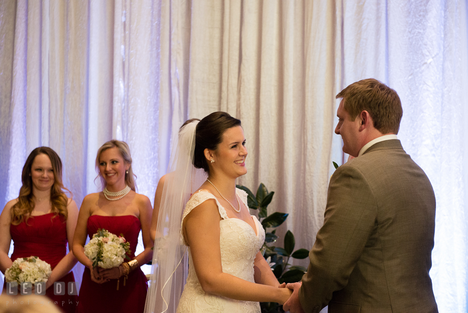 Bride and Groom smiling reciting their wedding vows during ceremony. Hyatt Regency Chesapeake Bay wedding at Cambridge Maryland, by wedding photographers of Leo Dj Photography. http://leodjphoto.com