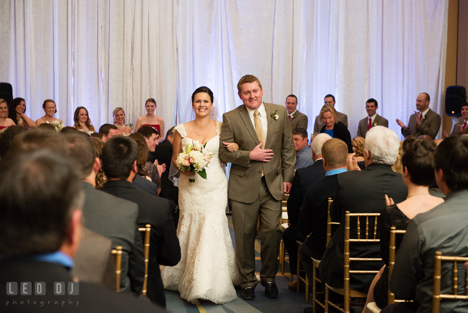 Bride and Groom walking out of the aisle during wedding ceremony recessional. Hyatt Regency Chesapeake Bay wedding at Cambridge Maryland, by wedding photographers of Leo Dj Photography. http://leodjphoto.com