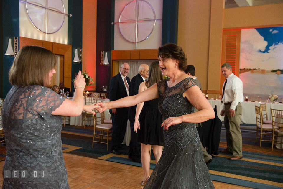 Mother of the Bride dancing with guest during wedding reception. Hyatt Regency Chesapeake Bay wedding at Cambridge Maryland, by wedding photographers of Leo Dj Photography. http://leodjphoto.com