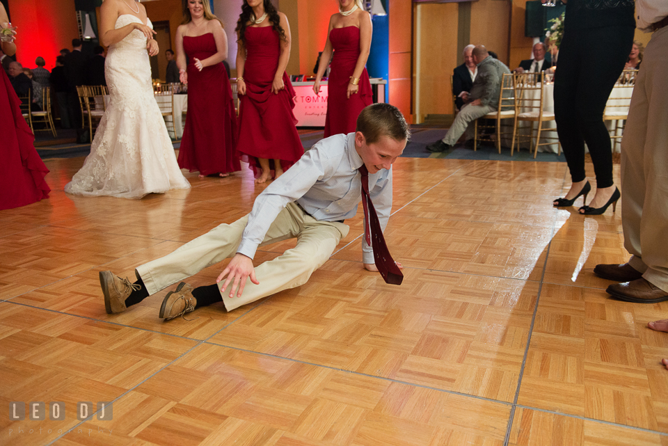 A young guest showing of his dance move on the floor during wedding reception. Hyatt Regency Chesapeake Bay wedding at Cambridge Maryland, by wedding photographers of Leo Dj Photography. http://leodjphoto.com