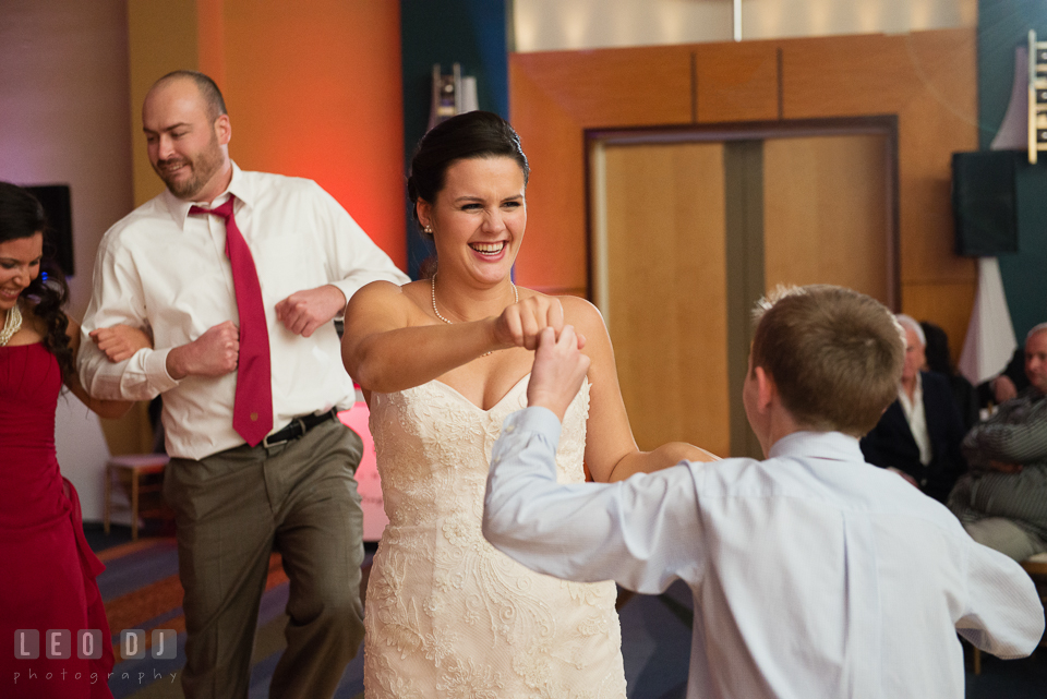 Bride smiling and dancing with guests during wedding reception. Hyatt Regency Chesapeake Bay wedding at Cambridge Maryland, by wedding photographers of Leo Dj Photography. http://leodjphoto.com