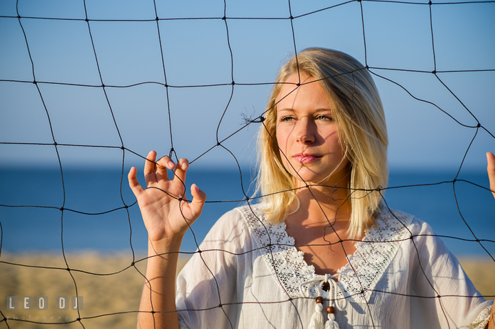 Girl holding volley ball net. Kent Island and Annapolis, Eastern Shore, Maryland model portrait photo session at Sandy Point Beach by photographer Leo Dj Photography. http://leodjphoto.com