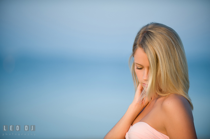 Gorgeous gril with blonde hair looking down. Kent Island and Annapolis, Eastern Shore, Maryland model portrait photo session at Sandy Point Beach by photographer Leo Dj Photography. http://leodjphoto.com