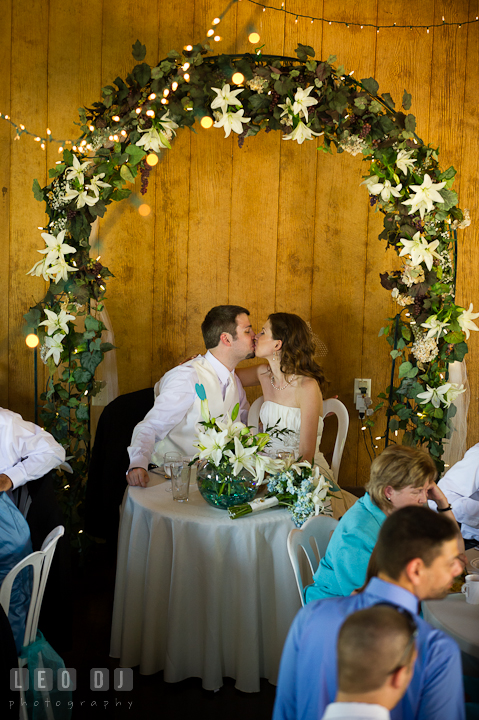 Bride and Groom kissing at the sweetheart table. Ostertag Vistas wedding reception photos at Myersville, Maryland by photographers of Leo Dj Photography. http://leodjphoto.com