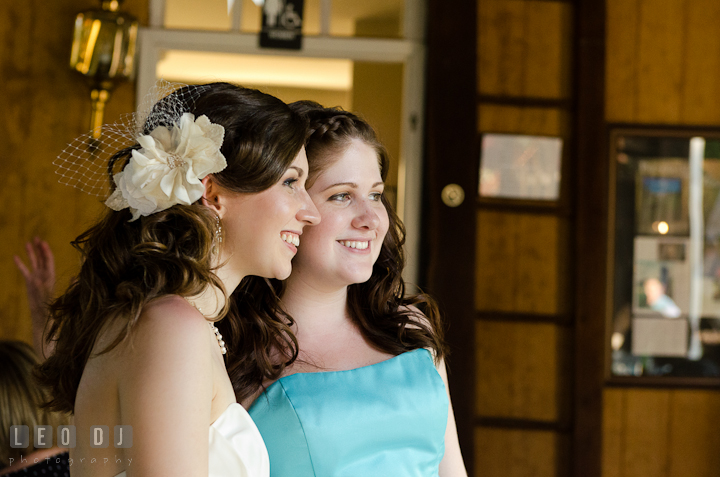 Bride and Maid of Honor smiling looking at guests dancing. Ostertag Vistas wedding reception photos at Myersville, Maryland by photographers of Leo Dj Photography. http://leodjphoto.com