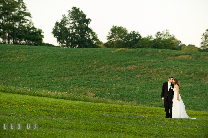 Bride and Groom kissing with a beautiful hilly landscape. Ostertag Vistas wedding reception photos at Myersville, Maryland by photographers of Leo Dj Photography. http://leodjphoto.com