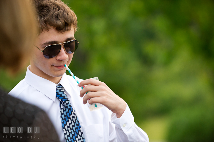 Bride's brother drinking cold beverage. Ostertag Vistas wedding reception photos at Myersville, Maryland by photographers of Leo Dj Photography. http://leodjphoto.com