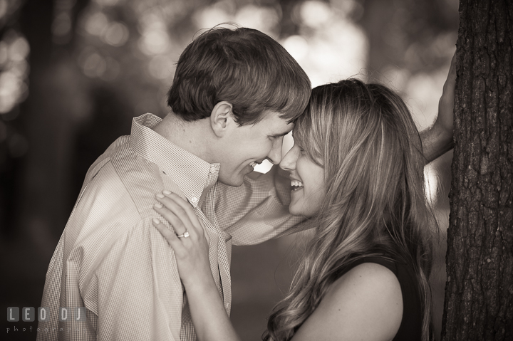 Engaged girl and her fiancée touching their heads together, smiling. Oxford, Eastern Shore Maryland pre-wedding engagement photo session, by wedding photographers of Leo Dj Photography. http://leodjphoto.com