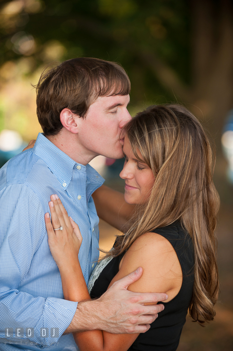 Engaged guy kissed his fiancée on the forehead. Oxford, Eastern Shore Maryland pre-wedding engagement photo session, by wedding photographers of Leo Dj Photography. http://leodjphoto.com