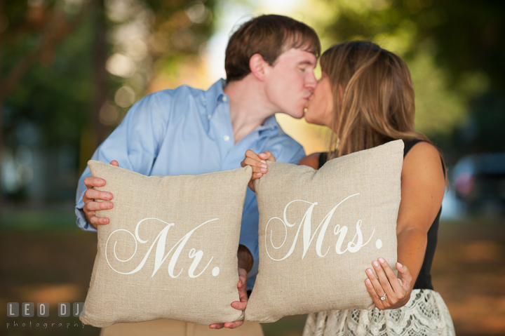 Engaged couple holding Mr. and Mrs. pillows. Oxford, Eastern Shore Maryland pre-wedding engagement photo session, by wedding photographers of Leo Dj Photography. http://leodjphoto.com