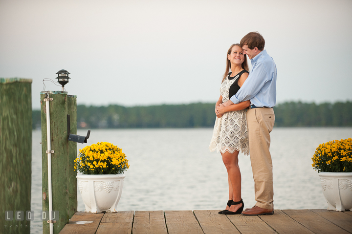 Engaged guy hugging his fiancée on a boat dock. Oxford, Eastern Shore Maryland pre-wedding engagement photo session, by wedding photographers of Leo Dj Photography. http://leodjphoto.com