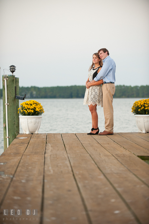 Engaged girl hugged by her fiancé. Oxford, Eastern Shore Maryland pre-wedding engagement photo session, by wedding photographers of Leo Dj Photography. http://leodjphoto.com