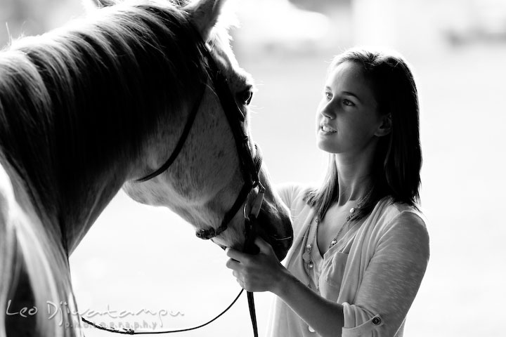 Girl looking at her horse. Annapolis Kent Island Maryland High School Senior Portrait Photography with Horse Pet by photographer Leo Dj