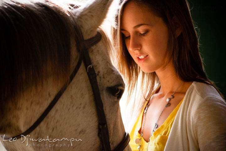 Girl looking at her horse. Annapolis Kent Island Maryland High School Senior Portrait Photography with Horse Pet by photographer Leo Dj