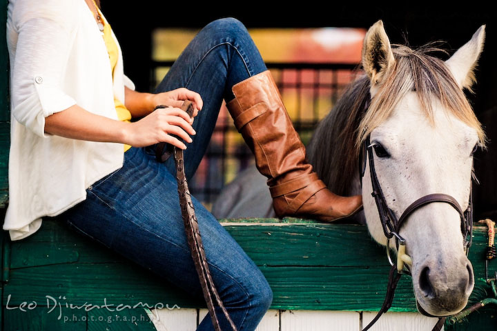 Mare poking head out of stable, owner sits on door. Annapolis Kent Island Maryland High School Senior Portrait Photography with Horse Pet by photographer Leo Dj