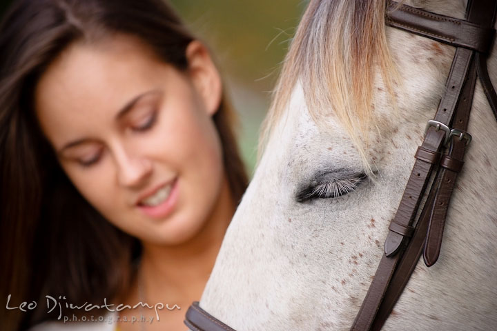 Horse closed eyes, enjoying being pet by owner. Annapolis Kent Island Maryland High School Senior Portrait Photography with Horse Pet by photographer Leo Dj