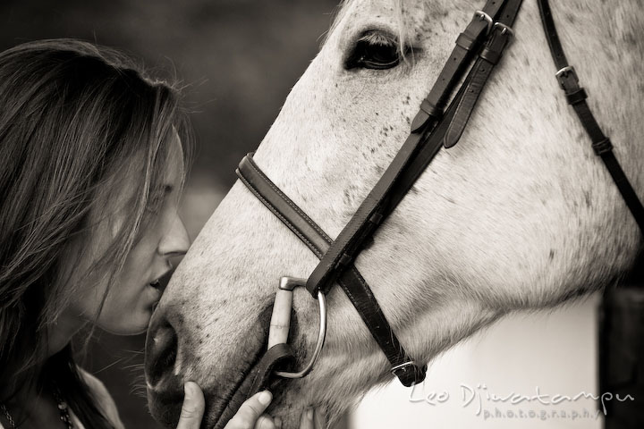 Girl owner touching nose with her mare. Annapolis Kent Island Maryland High School Senior Portrait Photography with Horse Pet by photographer Leo Dj