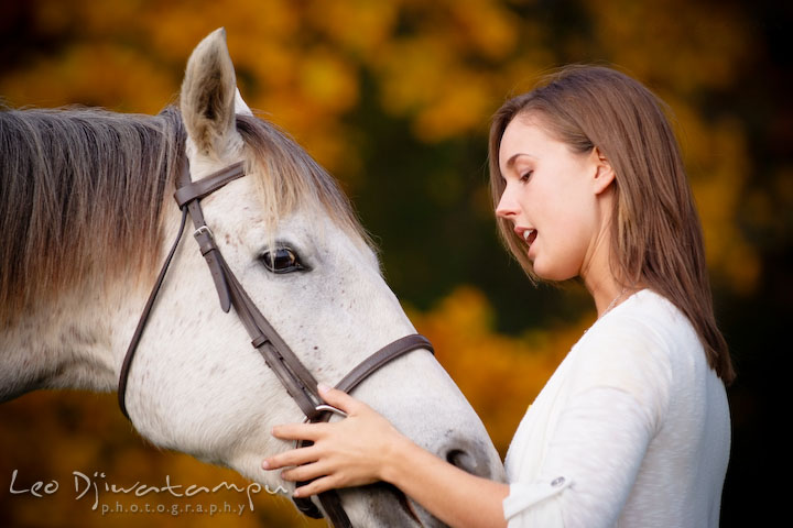 Girl owner talking with her mare. Annapolis Kent Island Maryland High School Senior Portrait Photography with Horse Pet by photographer Leo Dj