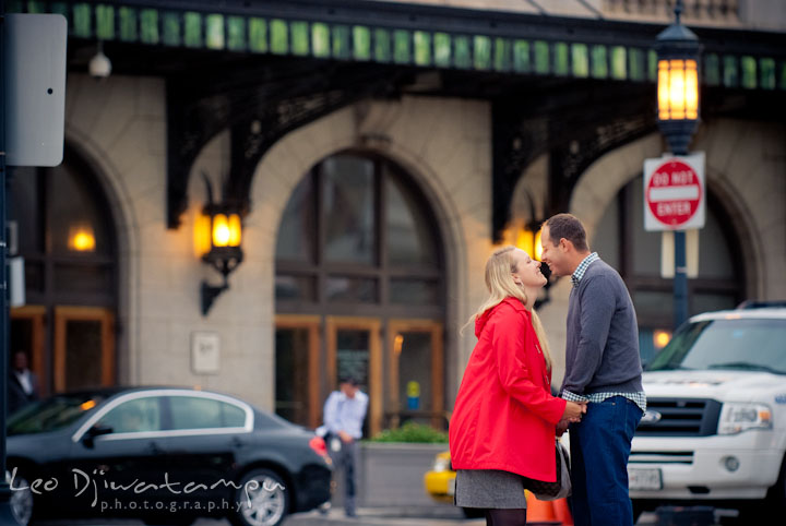 Engaged couple holding hands and laughing. Pennsylvania Train Station Baltimore Maryland pre-wedding engagement photo session by wedding photographer Leo Dj Photography.