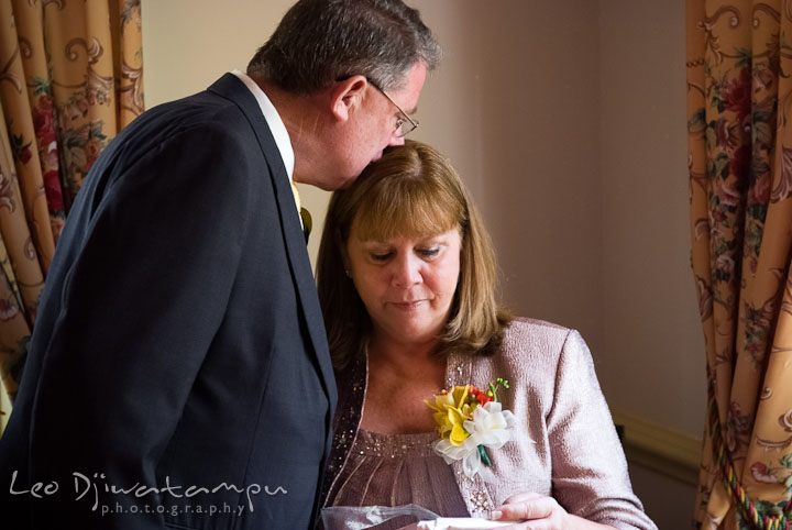 Father of Bride kissed Mom while she opens a gift. Mariott Aspen Wye River Conference Center Wedding photos at Queenstown Eastern Shore Maryland, by photographers of Leo Dj Photography.