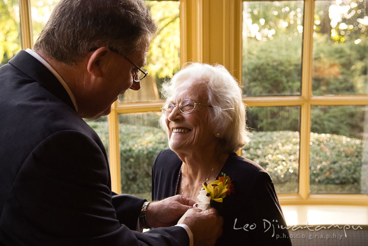 Father of Bride put on boutonniere on grandma. Mariott Aspen Wye River Conference Center Wedding photos at Queenstown Eastern Shore Maryland, by photographers of Leo Dj Photography.