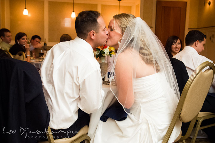 Bride and Groom kissing after glass clinks. Mariott Aspen Wye River Conference Center Wedding photos at Queenstown Eastern Shore Maryland, by photographers of Leo Dj Photography.