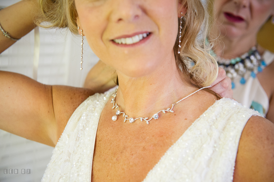 At home backyard wedding sister help Bride put on necklace photo by Leo Dj Photography