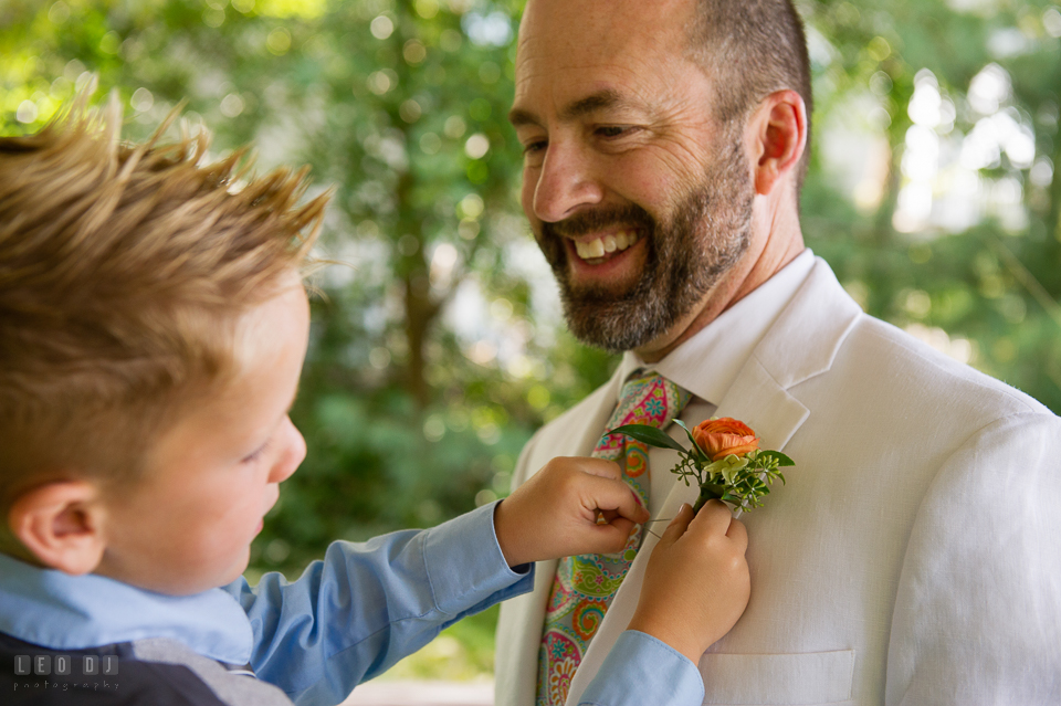 At home backyard wedding nephew put boutonniere on Groom photo by Leo Dj Photography