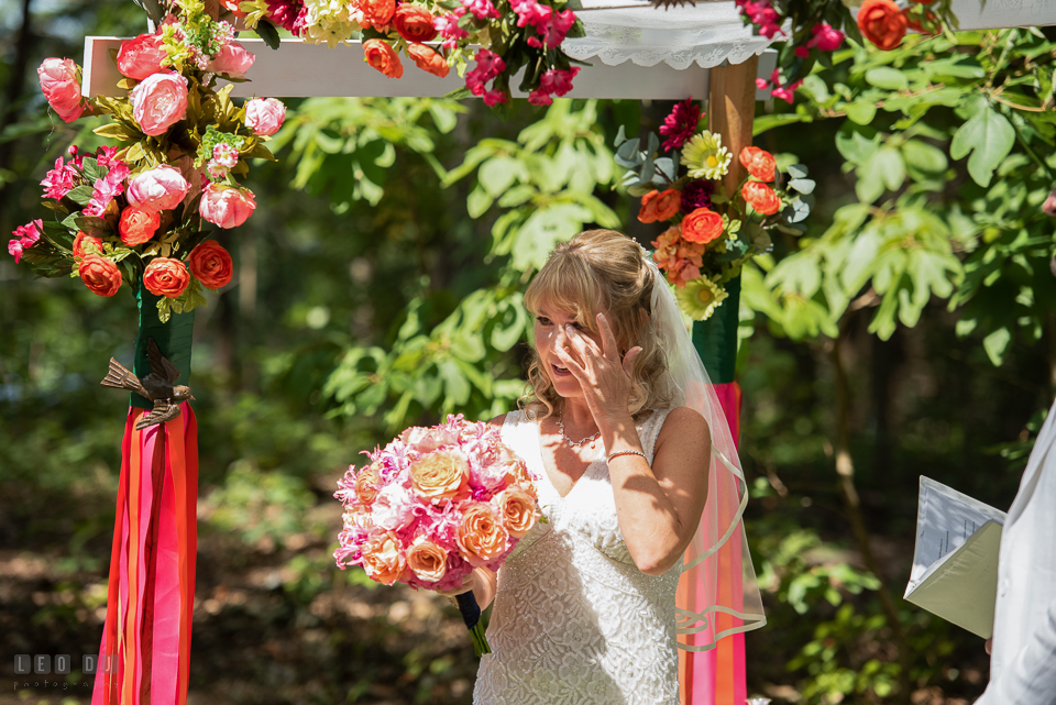 At home backyard wedding Bride wipe of tears hearing speech at ceremony photo by Leo Dj Photography