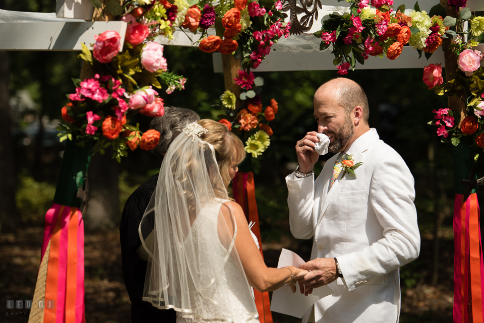 At home backyard wedding Groom wipe of tear while reciting vow at ceremony photo by Leo Dj Photography