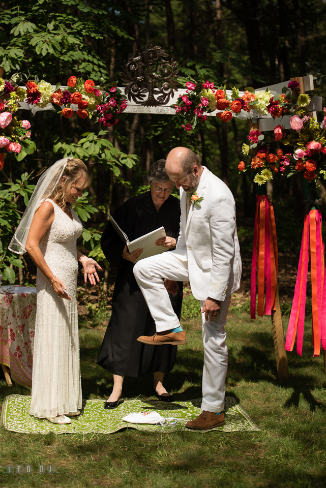 At home backyard wedding Groom stomp glass under chuppah at ceremony photo by Leo Dj Photography