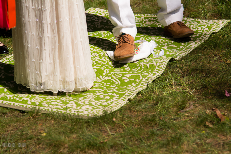 Annapolis Jewish wedding Groom stomp glass under chuppah at ceremony photo by Leo Dj Photography