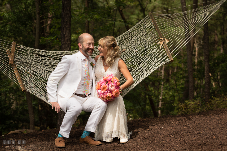 At home backyard wedding Bride and Groom sitting on hammock laughing photo by Leo Dj Photography