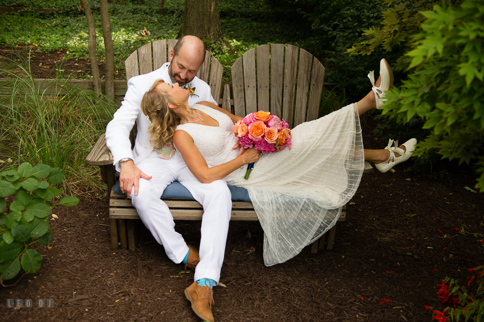 At home backyard wedding Bride lounging on bench with Groom photo by Leo Dj Photography