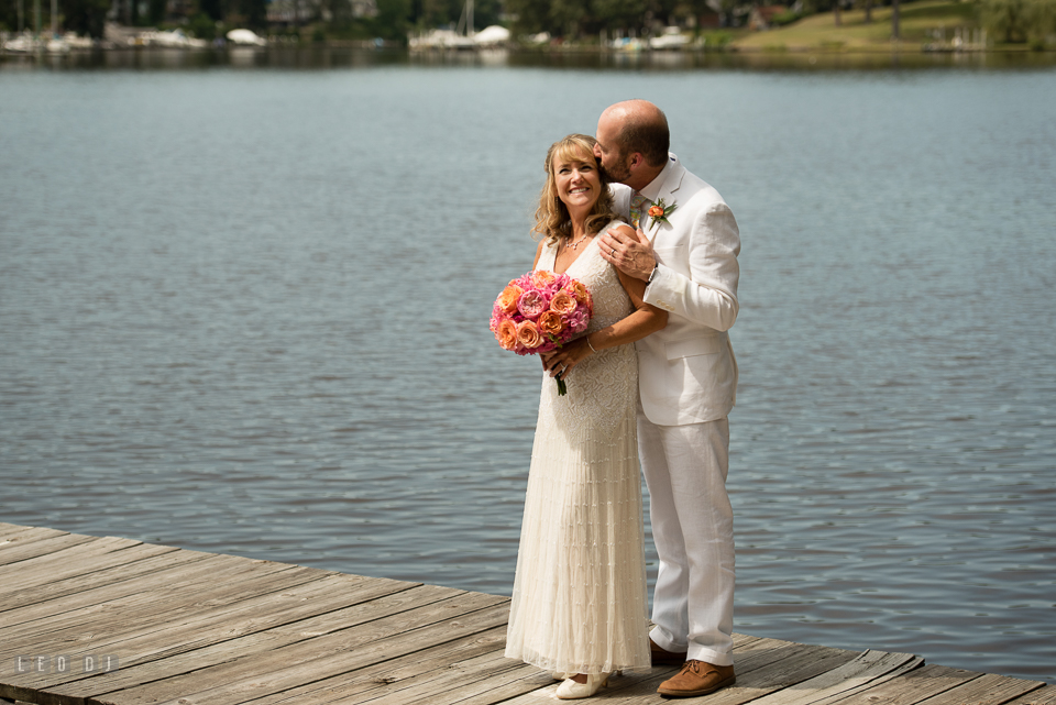 At home backyard wedding Groom kiss Bride on boat pier photo by Leo Dj Photography