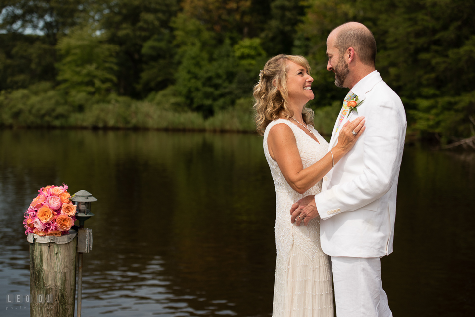 At home backyard wedding Bride and Groom holding each other on pier photo by Leo Dj Photography